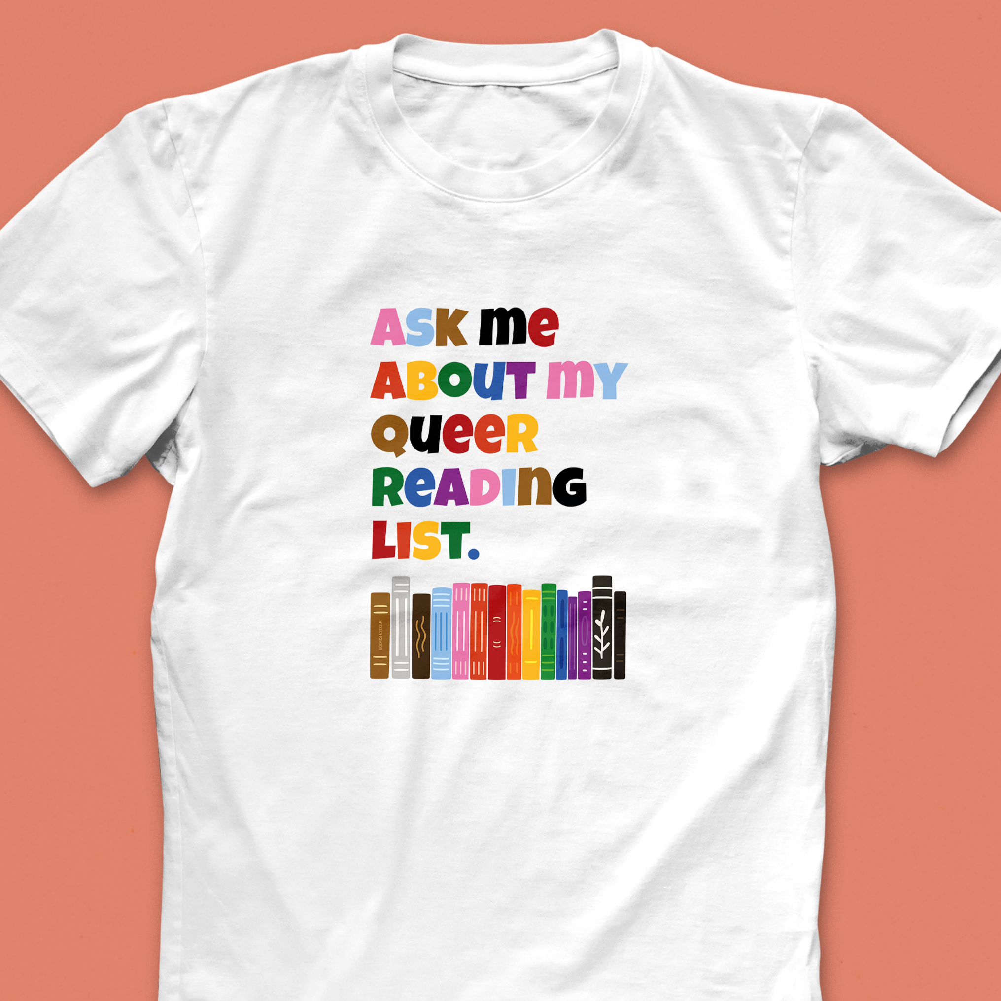 “Ask Me About My Queer Reading List” T-shirt with colourful rainbow text and illustrated book spines, designed for LGBTQ+ book lovers