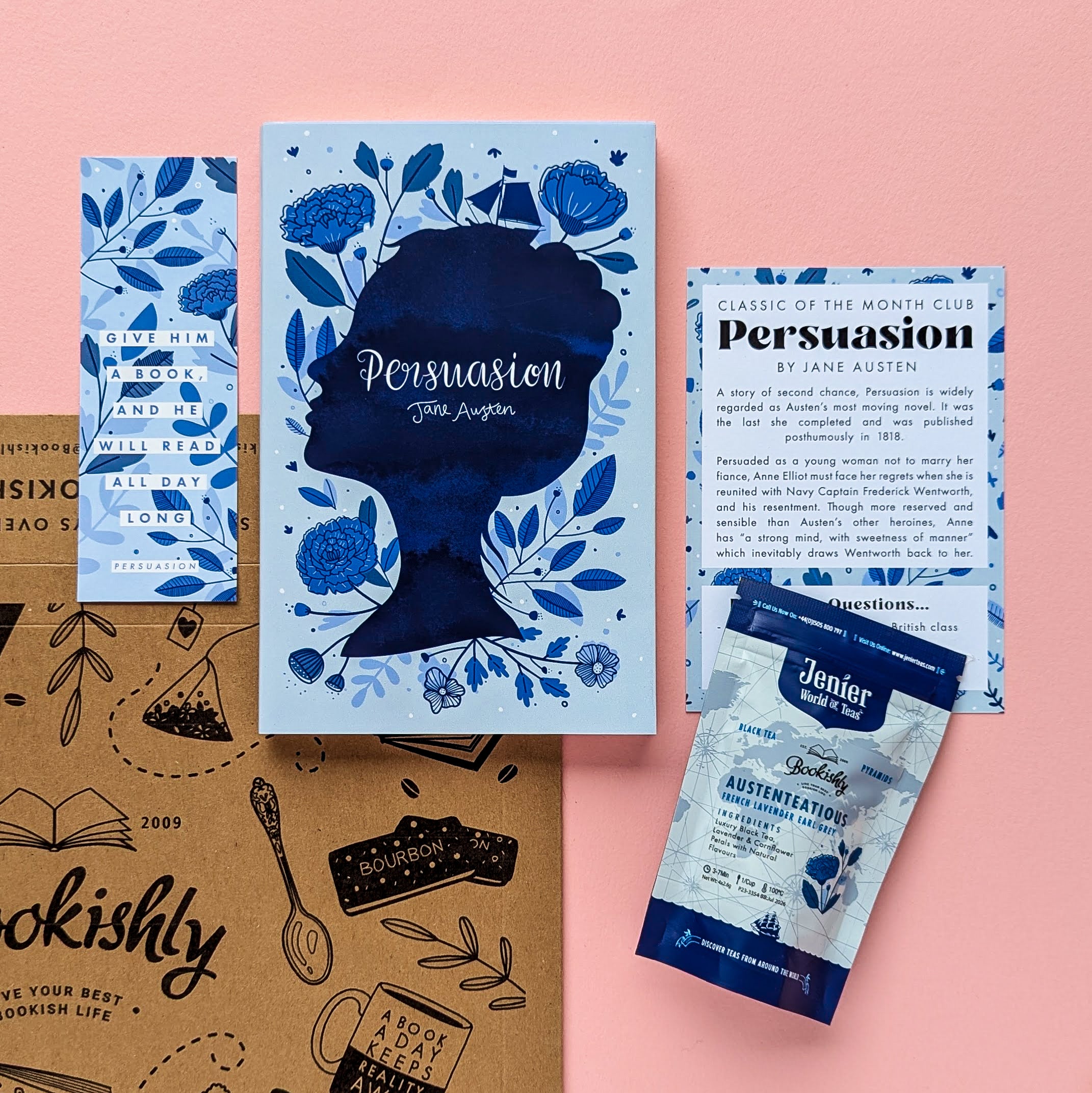 Persuasion subscription box flat lay – book with exclusive cover, coffee sachet, and activation card on pink background.
