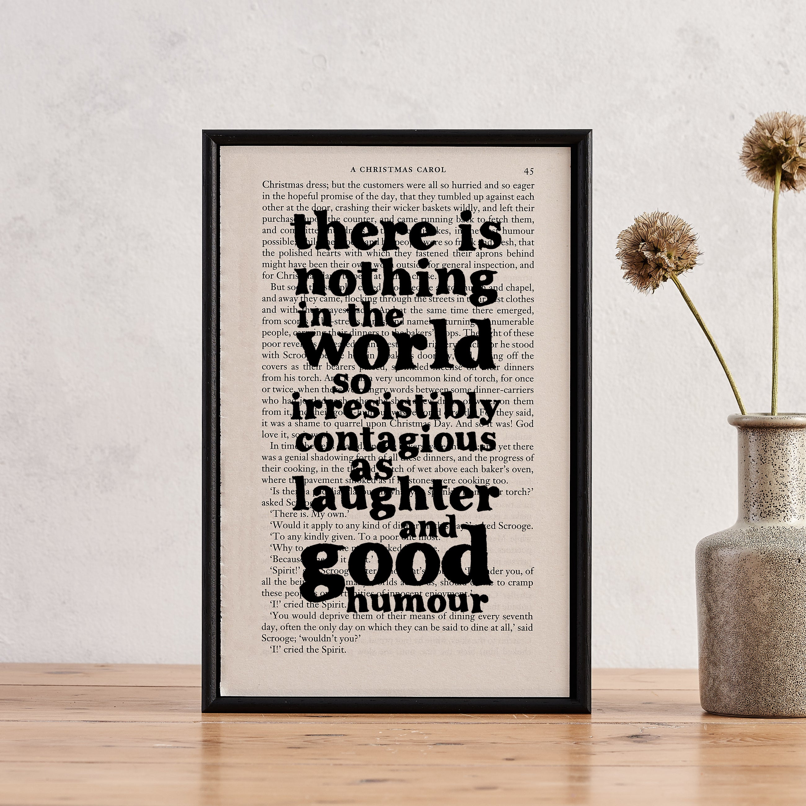 Framed book page art with the quote “There is nothing in the world so irresistibly contagious as laughter and good humour” printed onto a page from A Christmas Carol