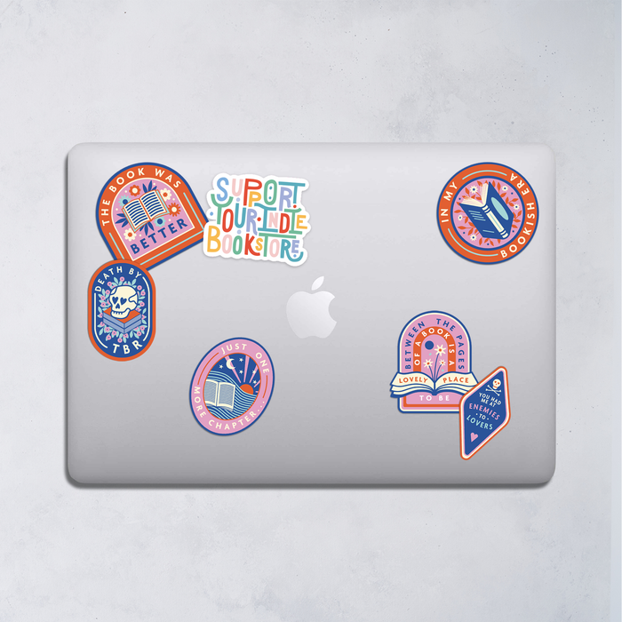 Support your indie bookstore. Support small businesses. Bookishly. Large Premium Die Cut Sticker featured on laptop with other range of stickers.