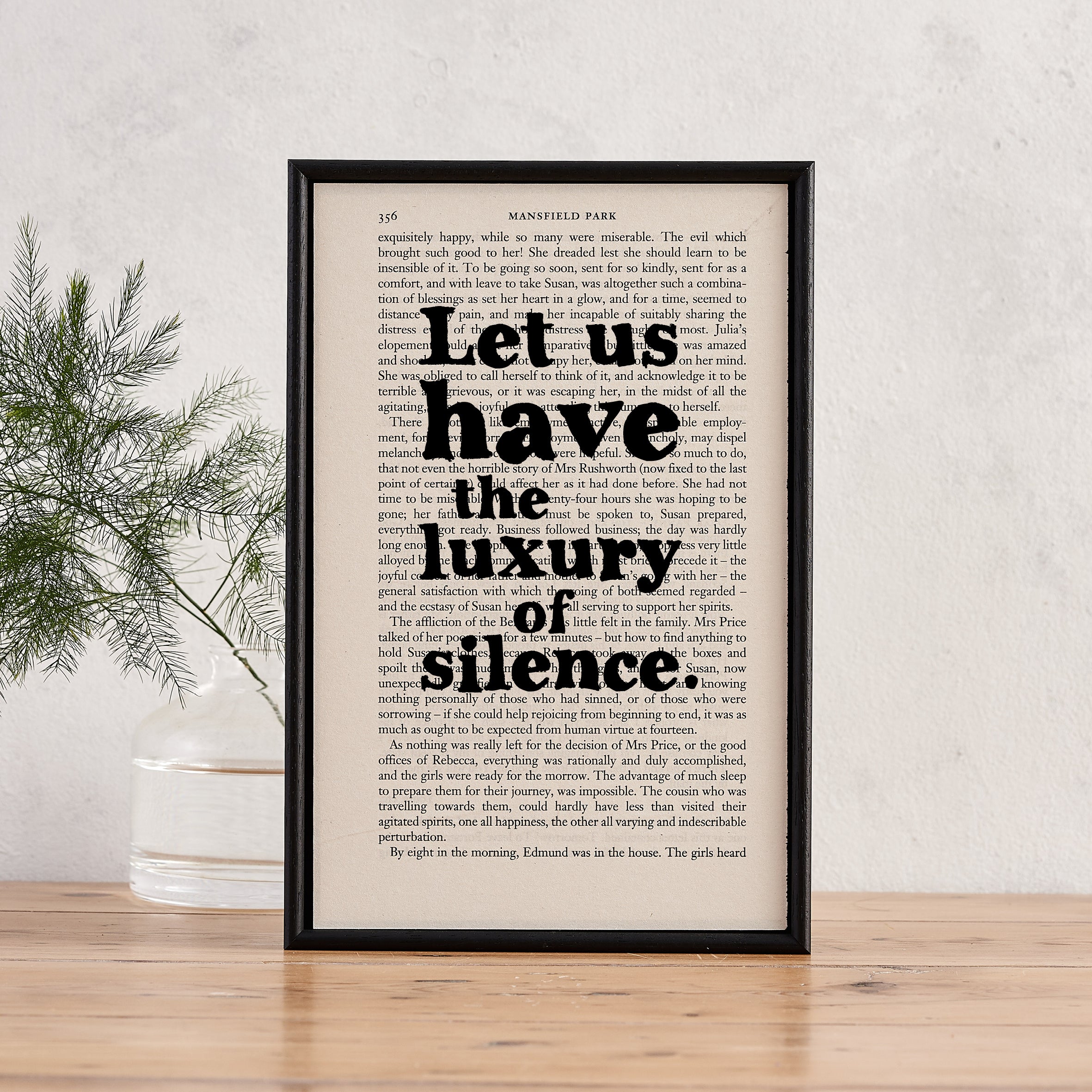 Framed book page print with the quote “Let us have the luxury of silence” in bold black text, printed over a vintage page from Mansfield Park