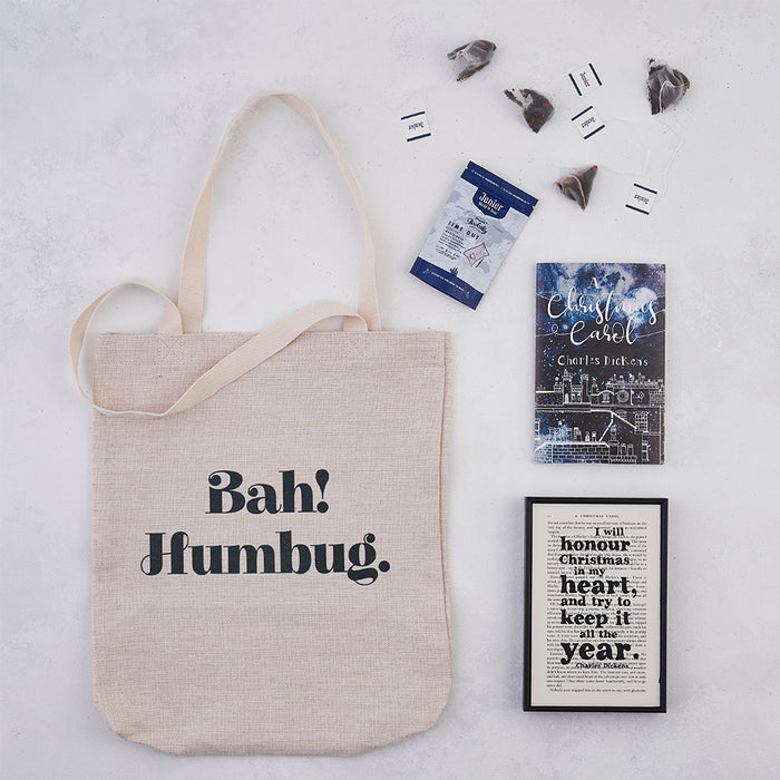 Christmas Hamper Gift Box. This festive gift features our Bah Humbug tote bag, I will honour Christmas Book Page Print, luxury literary themed tea bags and a copy of our A Christmas Carol Bookishly edition book.