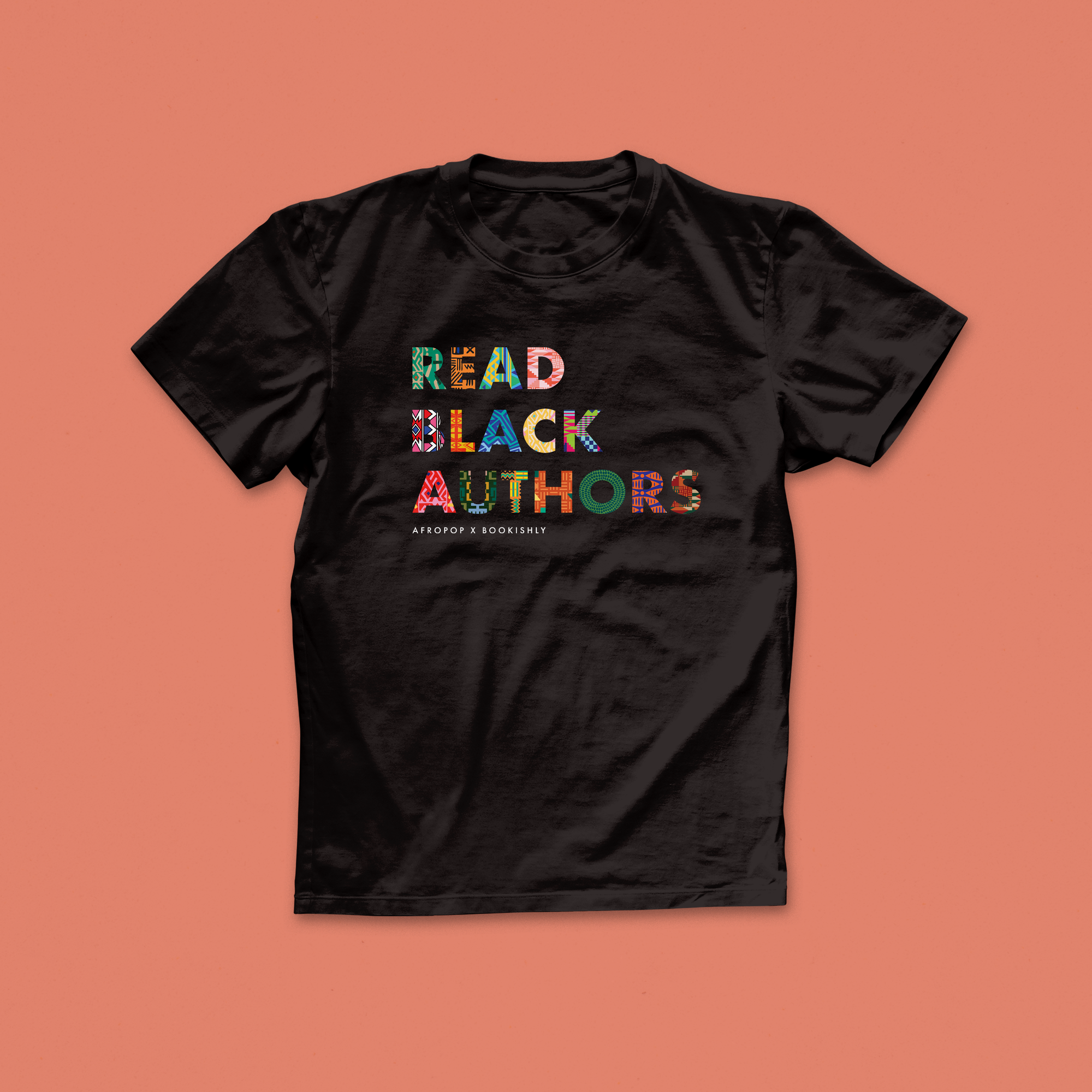 Read Black Authors T-shirt in bold African print-inspired lettering on black fabric, from the Afropop x Bookishly collaboration