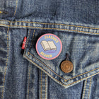 Classics Reader wooden pin attached to the pocket of a denim jacket.