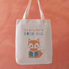 Personalised teacher tote bag with a fox reading a book and the text “Ms Roland’s Book Bag” printed above.