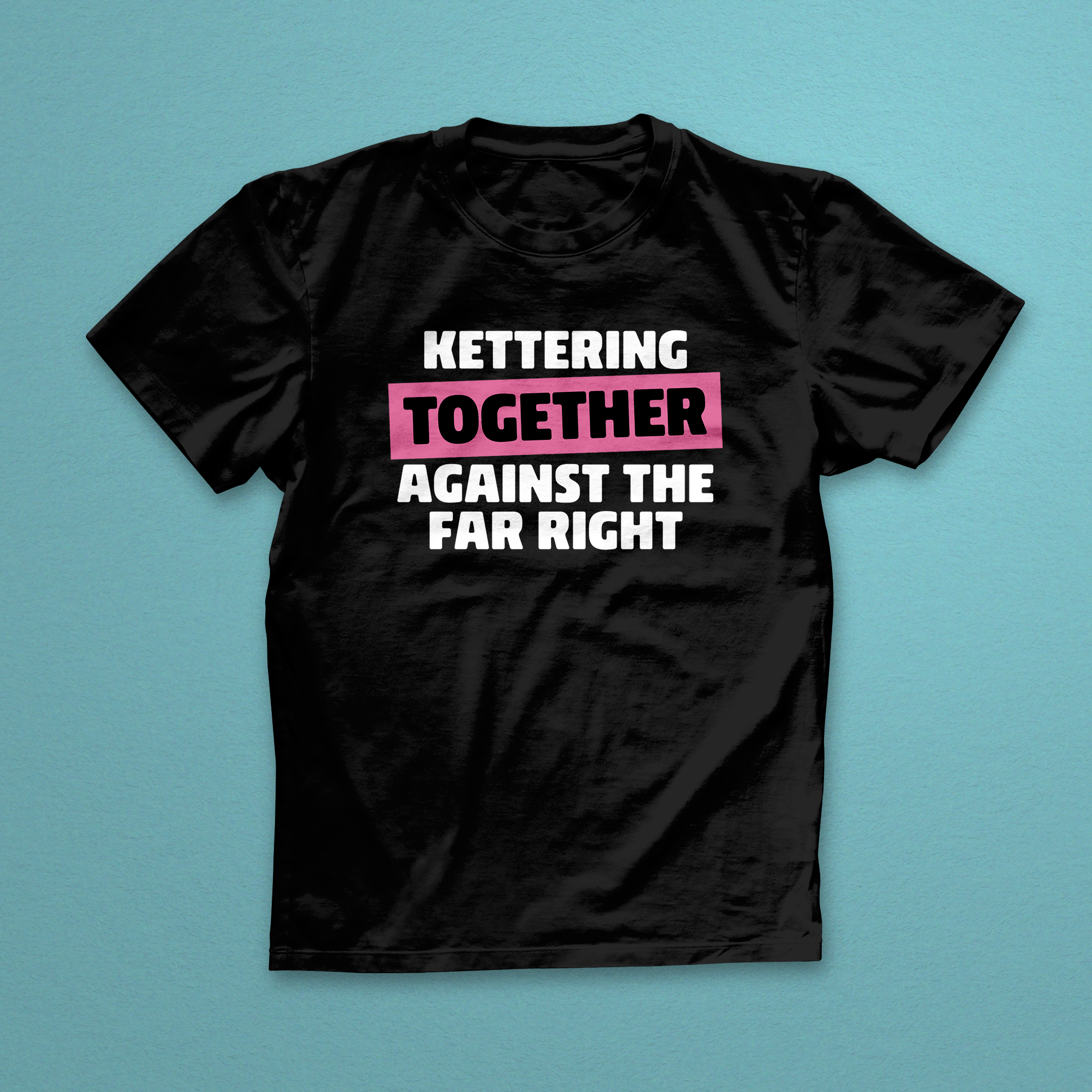 Black t-shirt with white and pink text on a blue background