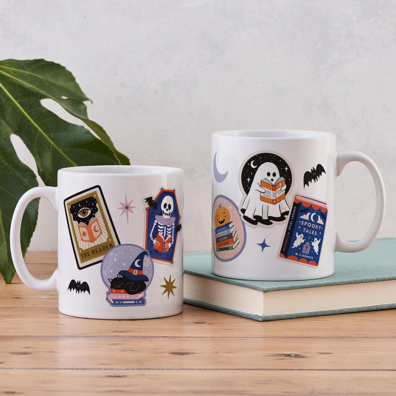 White ceramic mug with a colorful wrap-around collage of Halloween and bookish art.