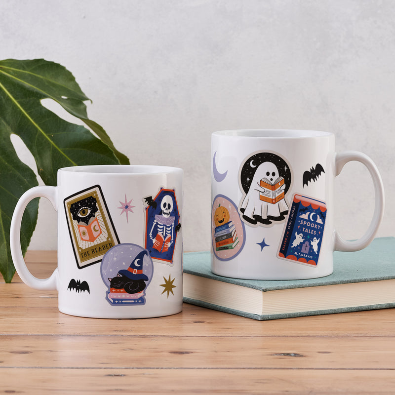 White ceramic mug with a colorful wrap-around collage of Halloween and bookish art.