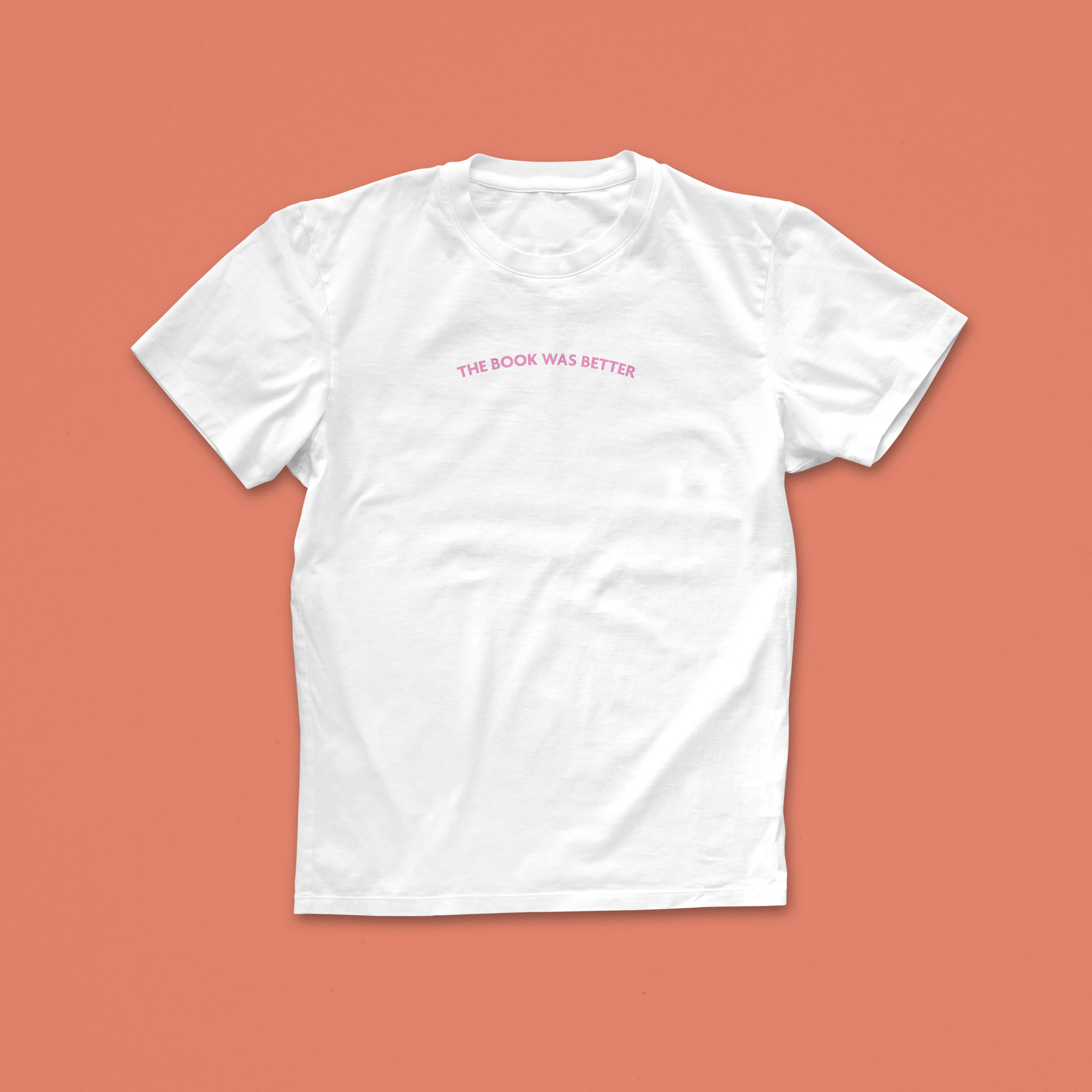 The Book Was Better T-shirt with minimalist curved pink text – subtle and funny tee for literary purists and book lovers