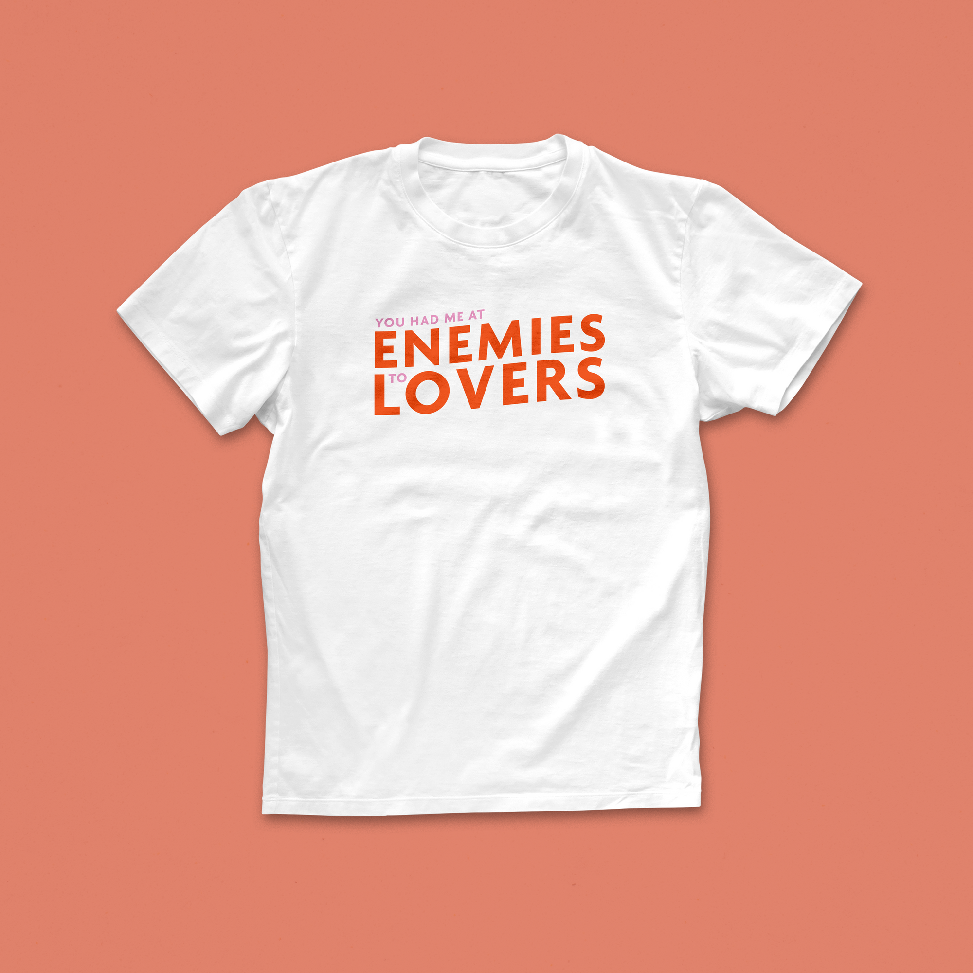 Enemies to Lovers T-shirt with bold orange and pink typography saying “You Had Me at Enemies to Lovers” – perfect for romance trope fans
