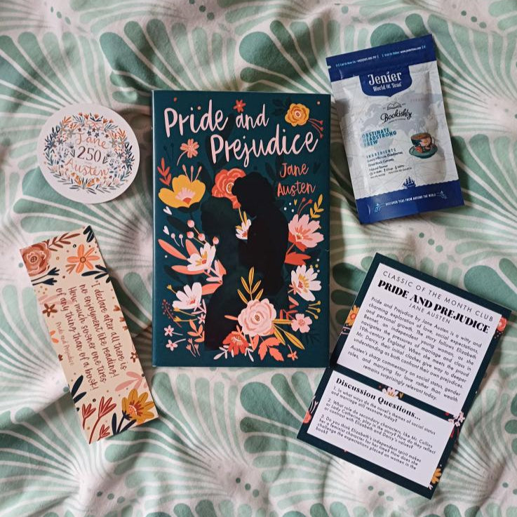 Book titled 'Pride and Prejudice' with a bookmark, sticker, and card on a patterned surface