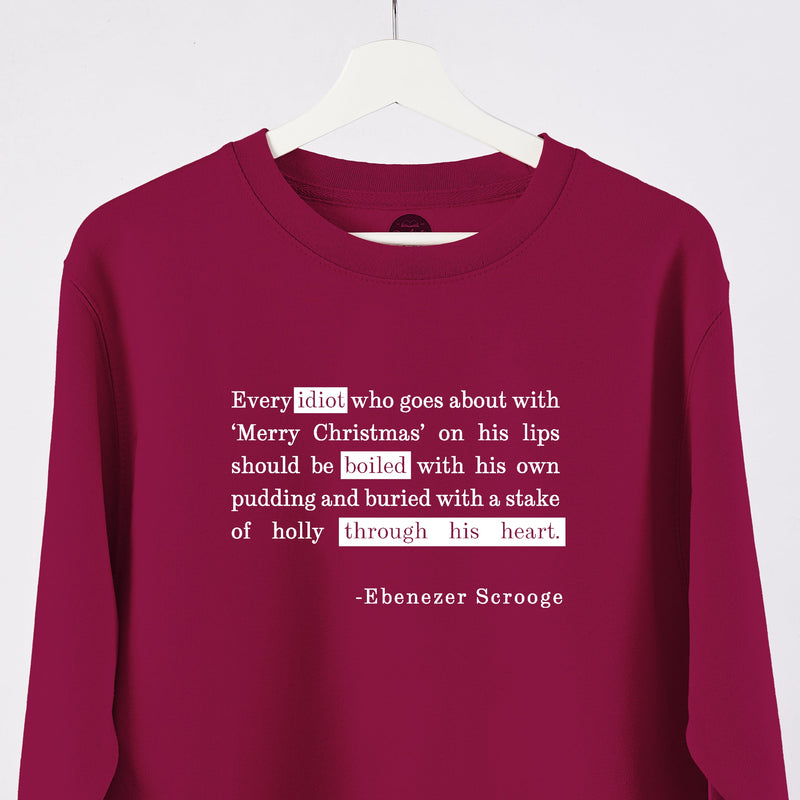 A cranberry jumper with a Dickens quote in white 