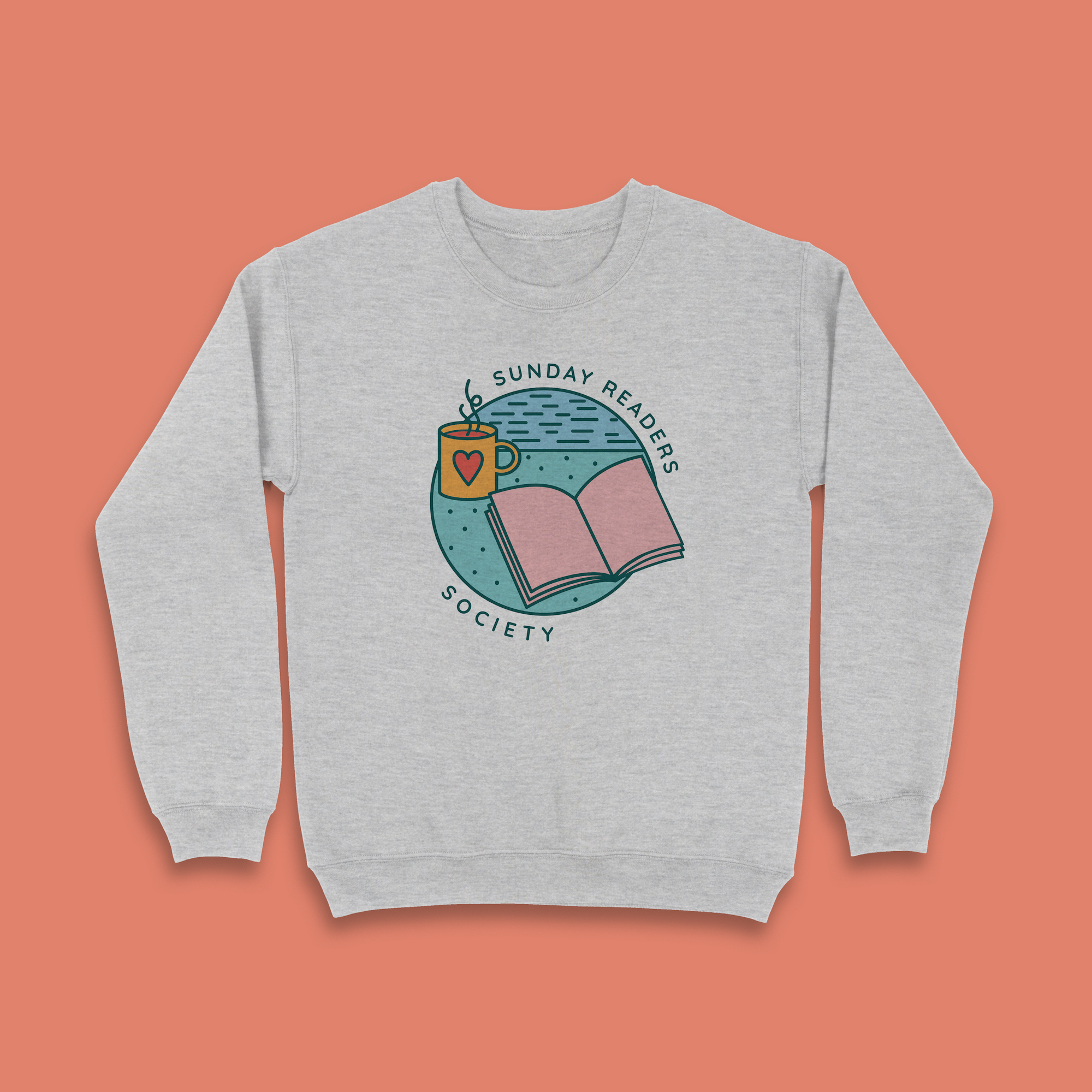 Grey sweatshirt with “Sunday Readers Society” design featuring an open book, mug with heart, and calm night sky illustration.