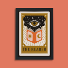 Framed art print with tarot card design showing an eye above an open book with sun and moon symbols, titled “The Reader.”