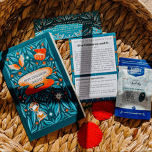 Books and a tea bag on a woven basket with a patterned background