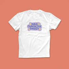 Main Character Energy T-shirt with purple and yellow hand-drawn text and sparkles, perfect for book lovers with big story vibes