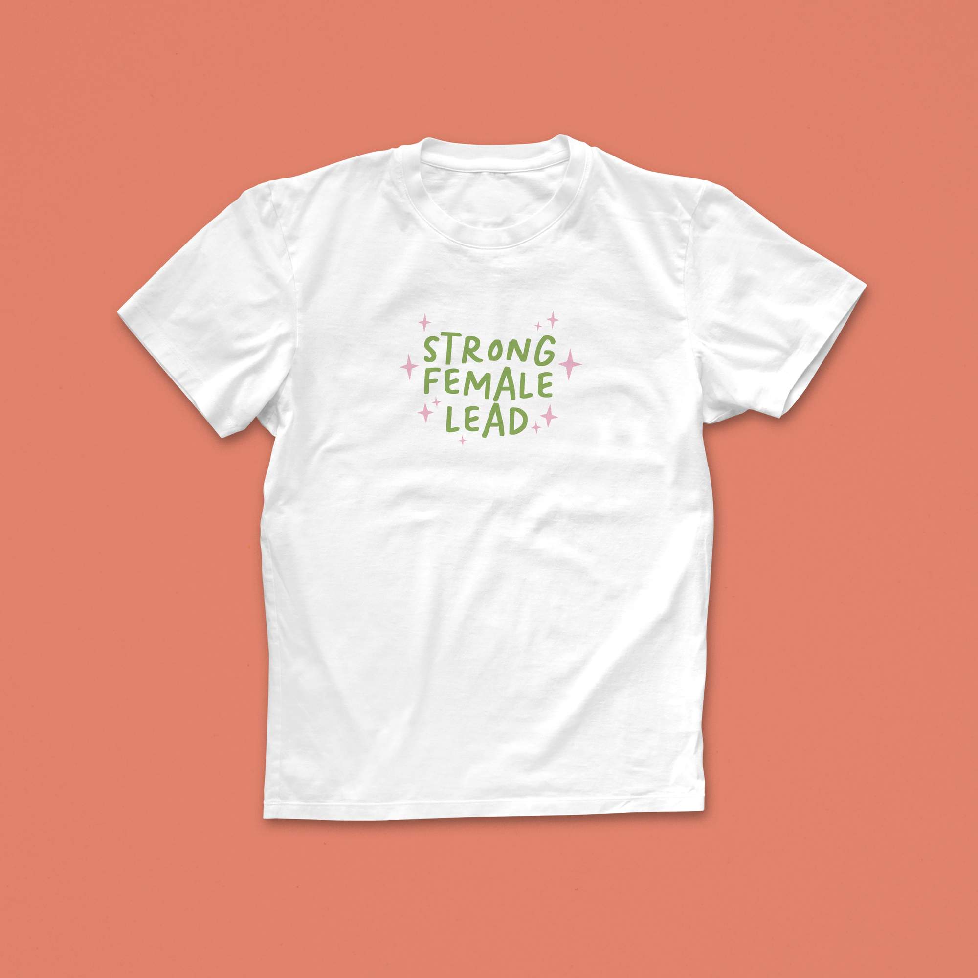 Strong Female Lead T-shirt with green and pink hand-drawn lettering and sparkles, designed for feminist readers and book lovers