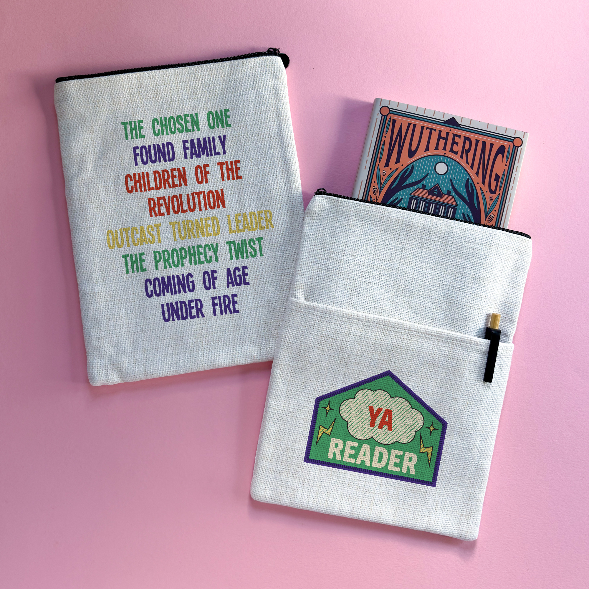 Double-sided YA Reader book sleeve with merit patch design on one side and rainbow YA tropes list on the other, styled on a pink background with a book and pen.