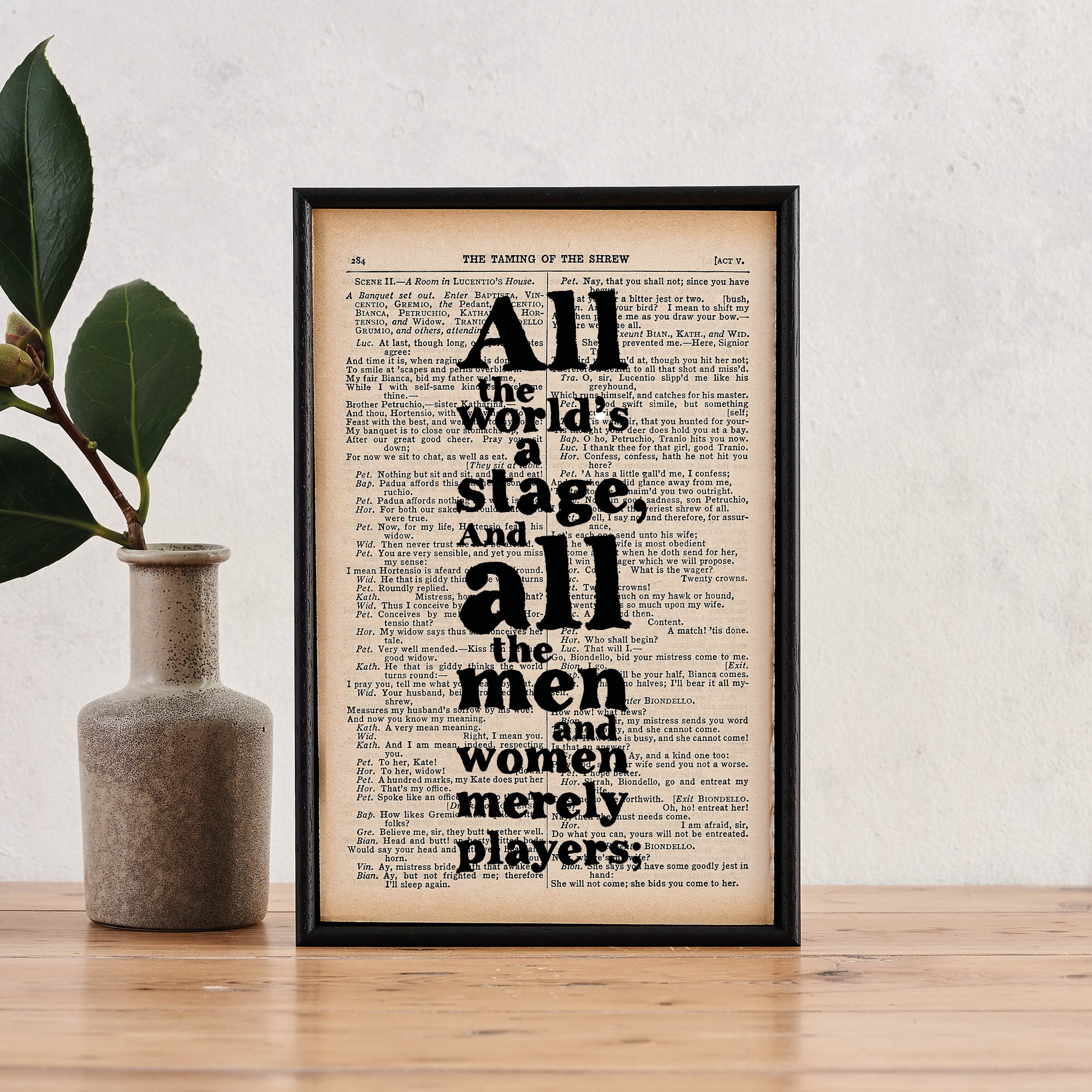 Framed book page print featuring the quote “All the world’s a stage. And all the men and women merely players” printed in bold black type on a page from The Complete Works of William Shakespeare.