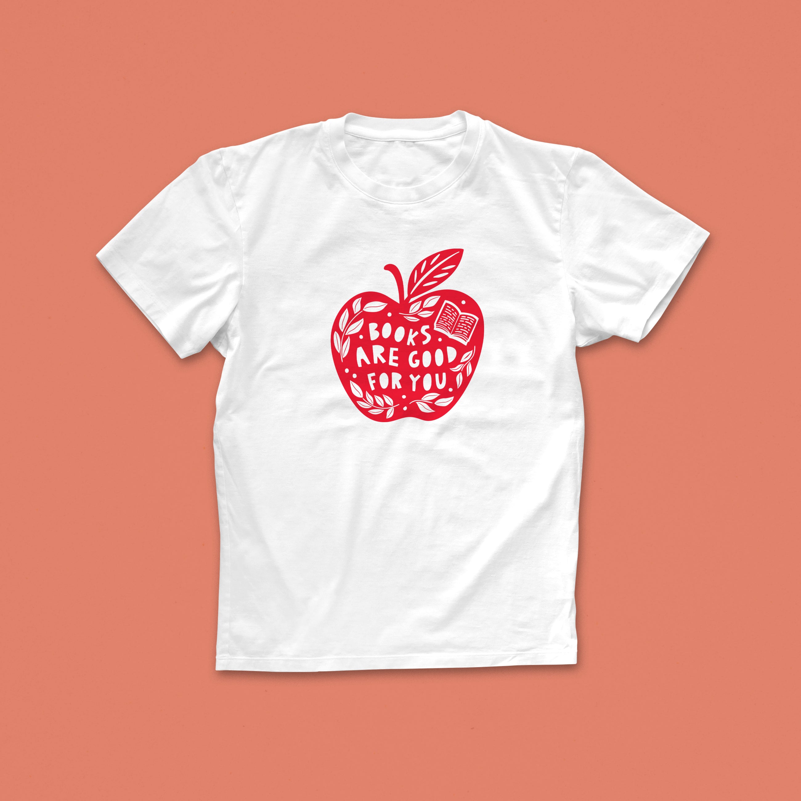 Books Are Good For You T-shirt with red apple and book illustration, featuring hand-lettered text, designed for book lovers and readers