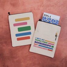 Fabric book sleeve with 'I buy my books from bookshops not billionaires on one side and a colour block design on the other.