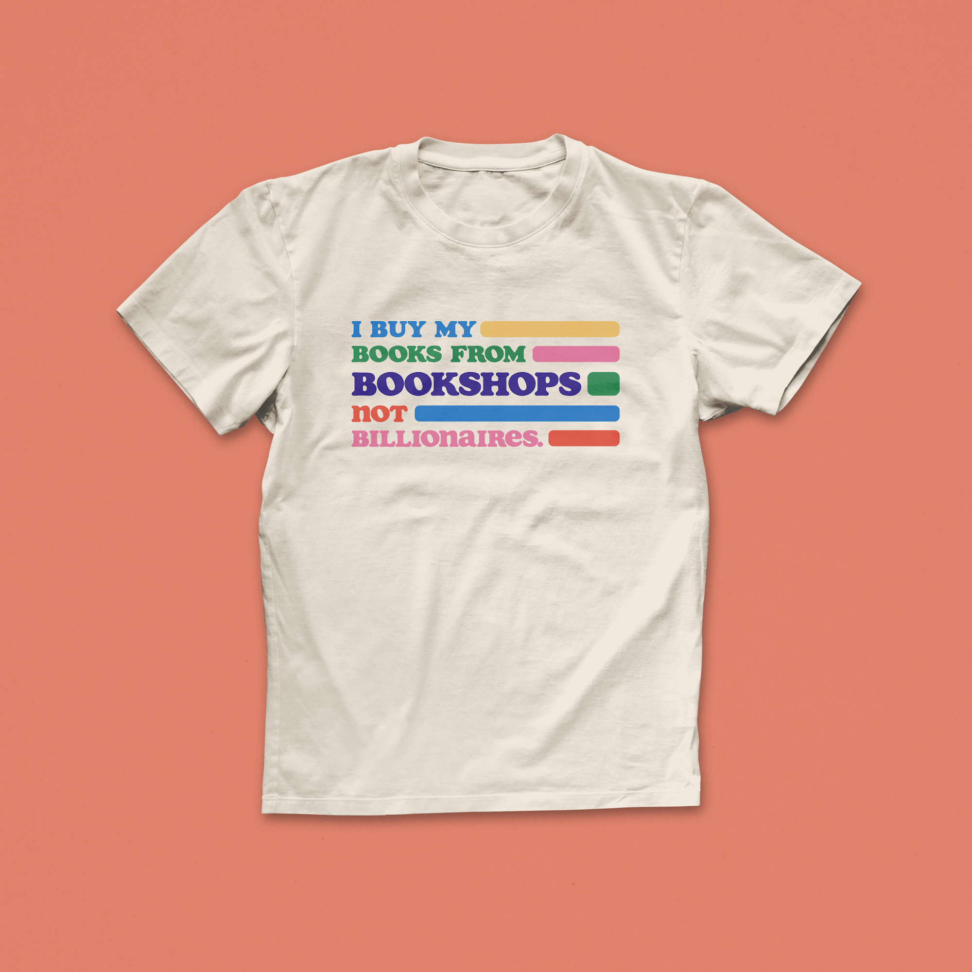 Bookshops Not Billionaires T-shirt with colourful rainbow text promoting ethical book buying, designed for indie bookshop supporters