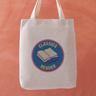 Classics Reader tote bag with a stitched badge-style design in blue, featuring an open book illustration and retro typography.
