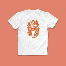 Knowledge Is Power T-shirt with hand-drawn illustration of a raised hand holding a book in rust-orange, surrounded by flowers and bold text