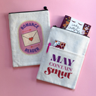 Double-sided book sleeve featuring “Romance Reader” on one side and “May Contain Smut” on the other, styled on a pink background with a book and pen.