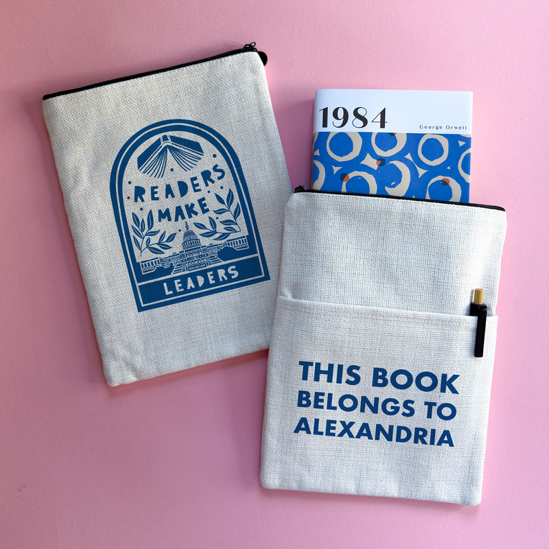 Personalised book sleeve featuring “Readers Make Leaders” design on one side and “This Book Belongs To Alexandria” text on the other, styled on a pink background with a copy of 1984.