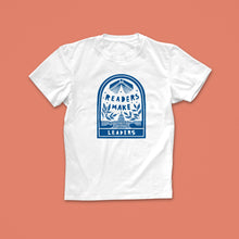 Readers Make Leaders T-shirt with blue hand-drawn illustration of an open book, leaves, and a civic building, designed for book lovers and changemakers