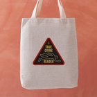 True Crime Reader tote bag with a stitched badge-style design featuring a chalk outline illustration in yellow on a black background.
