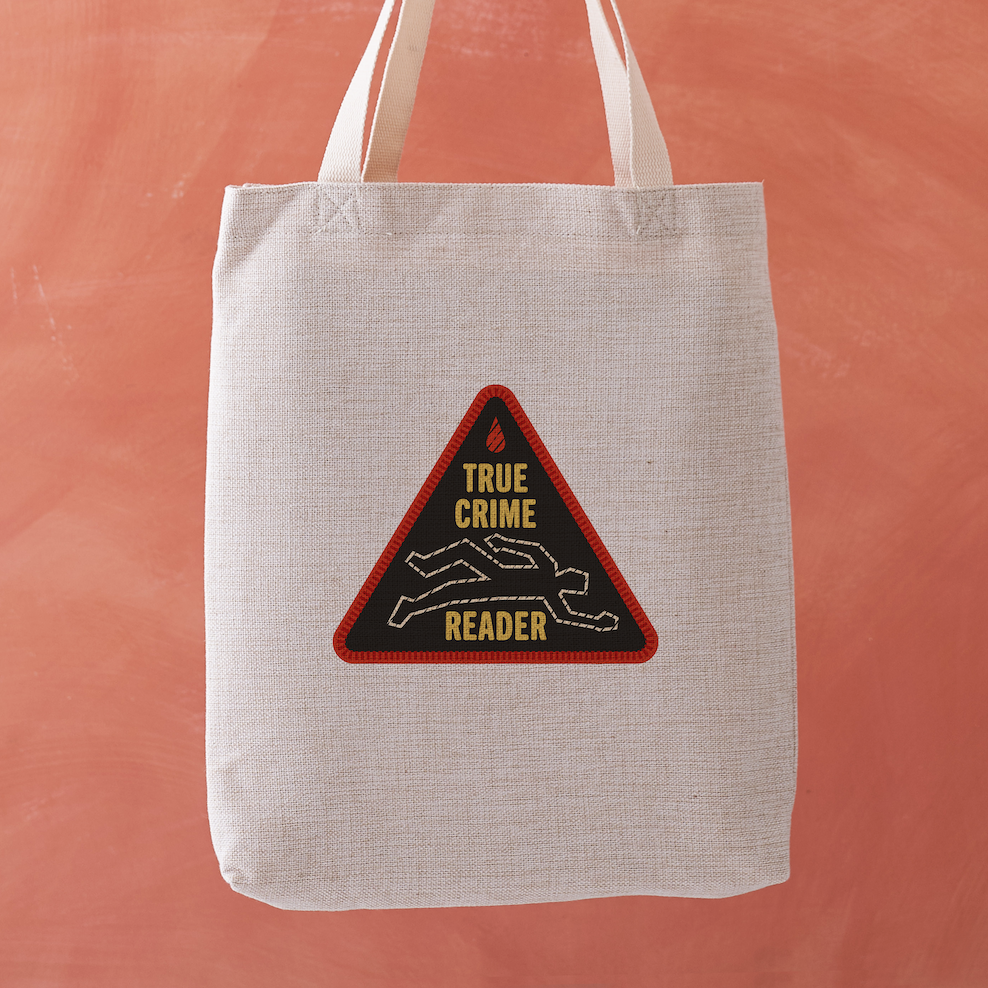True Crime Reader tote bag with a stitched badge-style design featuring a chalk outline illustration in yellow on a black background.

