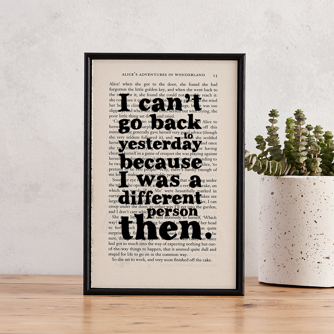 Framed book page print with the quote “I can’t go back to yesterday because I was a different person then” from Alice’s Adventures in Wonderland by Lewis Carroll