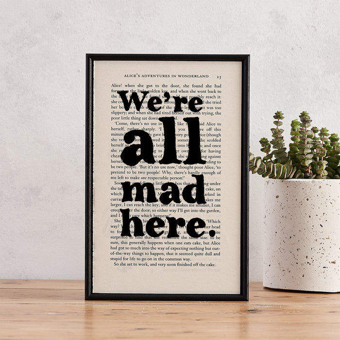alice in wonderland quotes "we're all mad here" framed print and perfect quirky housewarming gift. Perfect for book lovers, bookworms, bibliophiles and readers.