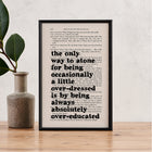 Framed book page print with Oscar Wilde quote: “The only way to atone for being occasionally a little overdressed is by being always absolutely overeducated,” printed on a play script page.