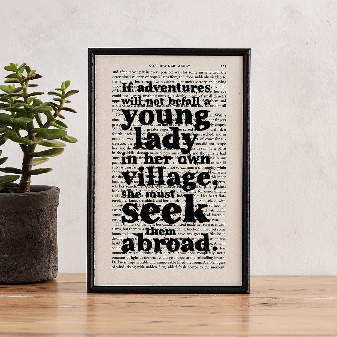 Framed book page print featuring the quote “If adventures will not befall a young lady in her own village, she must seek them abroad” from Northanger Abbey.