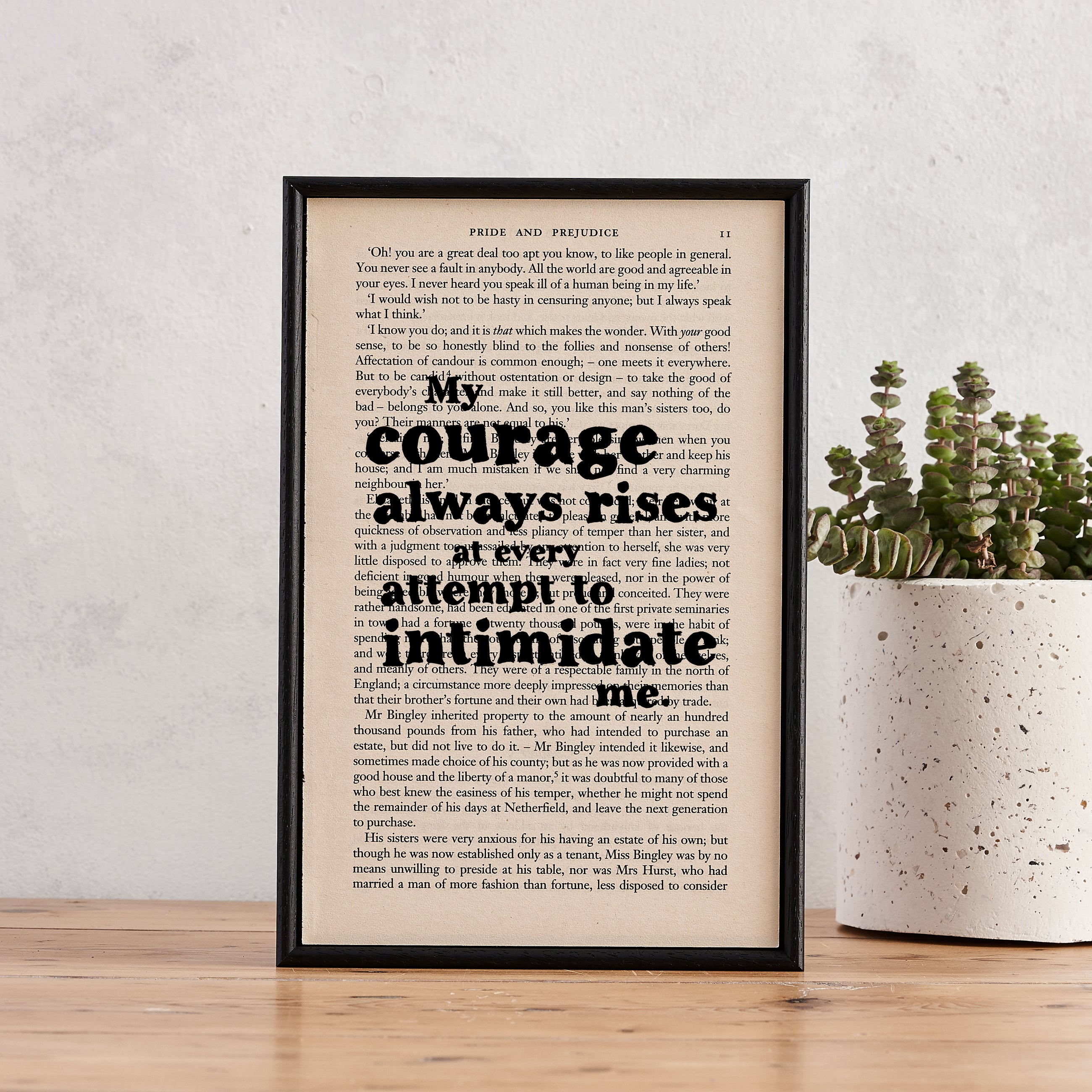 Framed book page print featuring the quote "My courage always rises at every attempt to intimidate me" from Pride and Prejudice.