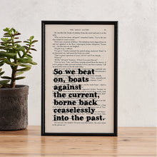 Framed book page print with the quote “So we beat on, boats against the current, borne back ceaselessly into the past” from The Great Gatsby by F. Scott Fitzgerald