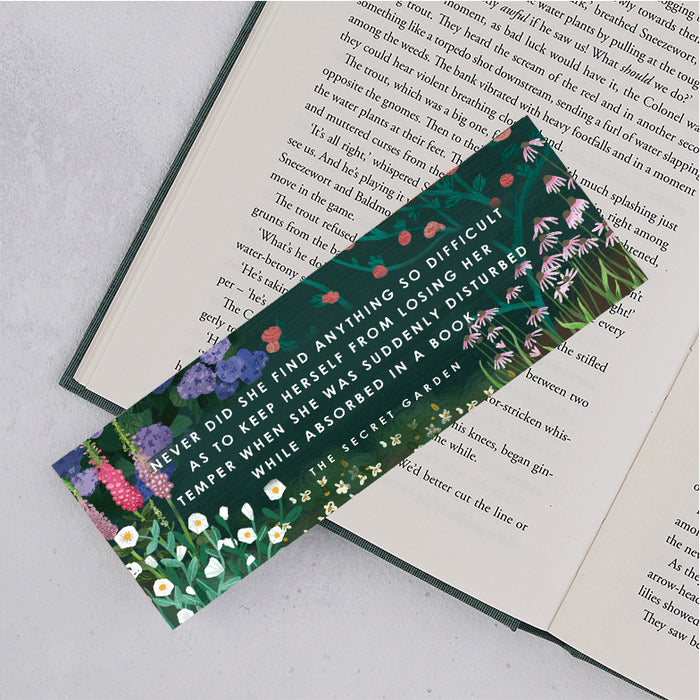 the secret garden bookmark with floral design and green background and the following quote "never did she find anything so difficult as to keep herself from losing her temper when we was suddenly disturbed while absorbed in a book"