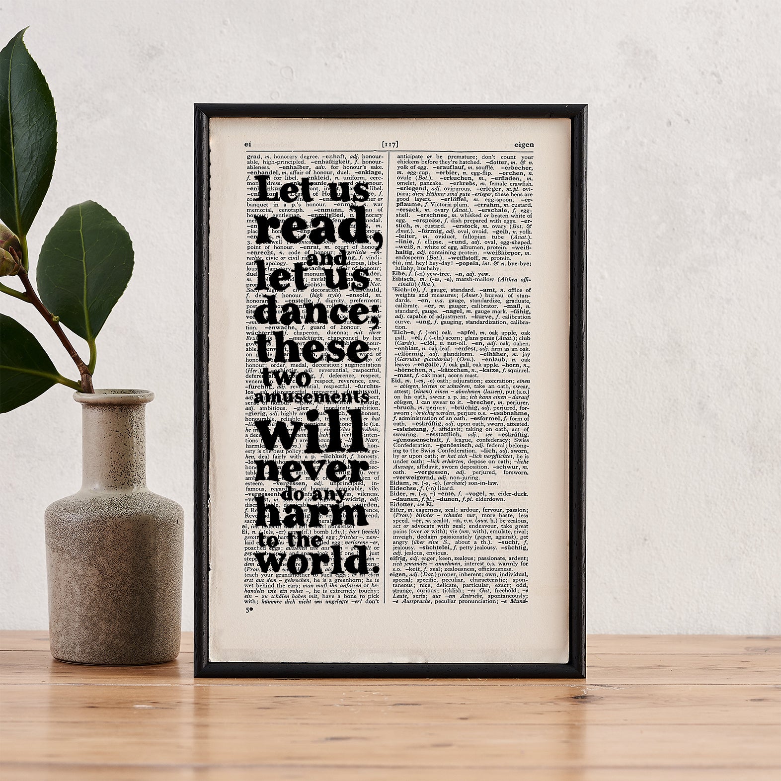 Framed book page print featuring the quote “Let us read, and let us dance; these two amusements will never do any harm to the world,” printed on a dictionary page.