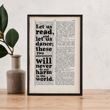 Framed book page print featuring the quote “Let us read, and let us dance; these two amusements will never do any harm to the world,” printed on a dictionary page.