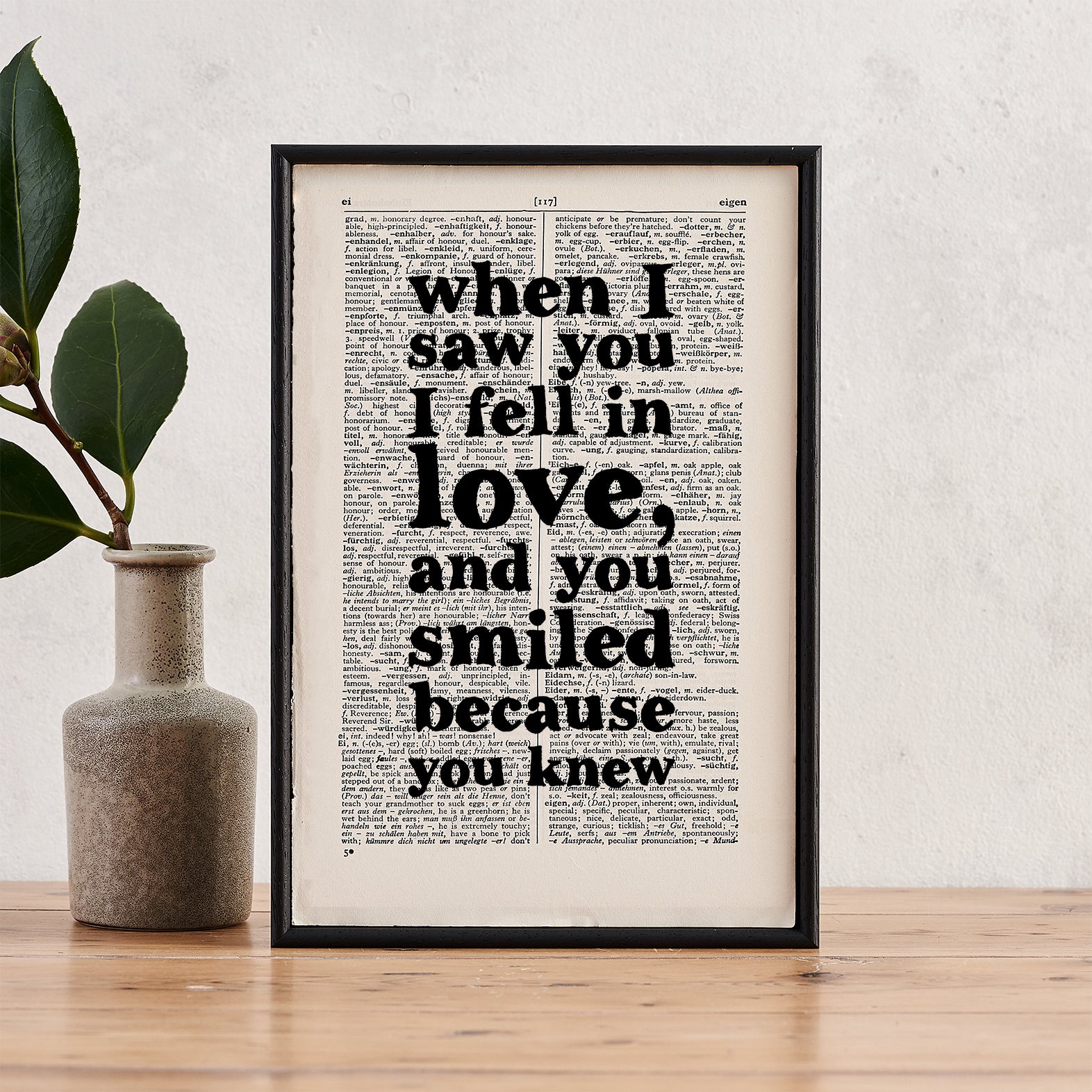 Framed book page print featuring the quote “When I saw you I fell in love, and you smiled because you knew” printed in bold black type on a vintage-style book page.